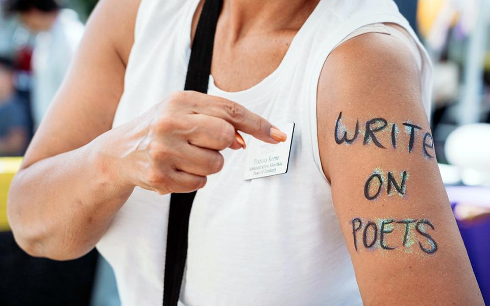 Person pointing to writing on arm
