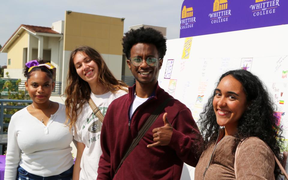 Students posing at the Big Poet Give wall